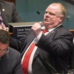Toronto Mayor Rob Ford (right) gestured to City Councillor Paul Ainslee as the councillors looked to pass motions to limit Ford’s powers.