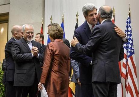 Iranian Foreign Minister Mohammad Javad Zarif (left) reacted next to EU foreign policy chief Catherine Ashton (center) as US Secretary of State John Kerry (second from right) embraced French Foreign Minister Laurent Fabius in Geneva.
