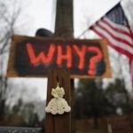 A knitted angel and a sign hung near a cemetery last December in Newtown, Conn. In a report Monday, Adam Lanza was described as having “mental health issues.”
