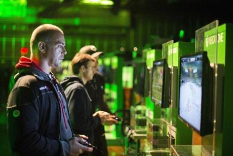 Fans played video games on Xbox One consoles during a midnight launch event in New York City last week.
