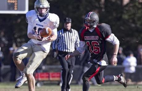 Needham High's Ben Newman made a reception in front of Wellesley High's Matt Dziama during fourth quarter action.
