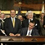 Mitt Romney, shown signing the Massachusetts health care bill in 2006, said during his presidential run that the state’s  reform wouldn’t work for the whole country.