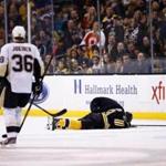 Brad Marchand is down on the ice after being kneed in the head by James Neal. (Photo by Jared Wickerham/Getty Images)