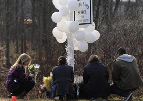 Teenagers placed flowers at the entrance to Sandy Hook Elementary School in Connecticut last year after 20-year-old Adam Lanza fired more than 150 rounds from his mother’s semiautomatic rifle.
