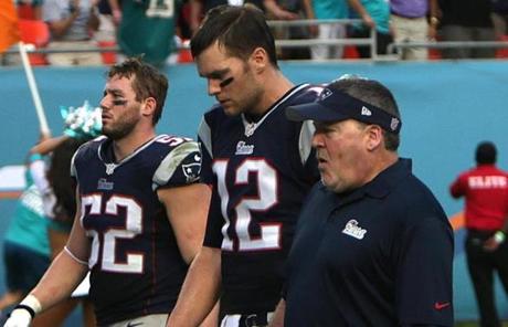 Tom Brady, center, walked off the field after a frustrating loss in Miami on Sunday.  
