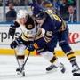Brad Marchand and Marcus Foligno battled for the puck.