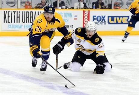 Predators left wing Viktor Stalberg reached for the puck ahead of Bruins center Ryan Spooner, who had three assists in the game.
