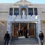 Iraqi police officers guard the entrance of St. Joseph's Chaldean Church before a Christmas mass in Baghdad, Iraq, Wednesday, Dec. 25, 2013. Militants on Wednesday launched two separate attacks against Christians in Baghdad, officials said. 