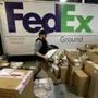 Package handler Chris Addison arranged packages before loading a delivery truck at a FedEx sorting facility in Kansas City, Mo., on Dec. 16. 