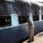 Indian policemen inspected a charred carriage after a fire engulfed the train. 