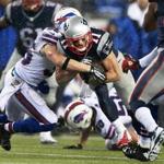 Patriots receiver Julian Edelman picks up some yards after the catch in the first quarter against the Bills.