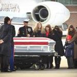 Erin Vasselian, (center), the widow of Marine Sgt. Daniel Vasselian, stood by her husband's coffin, which was flown to Boston Logan International Airport. 