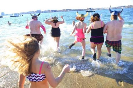 Hundreds of half-naked revelers stampeded into the Boston Harbor for the annual Polar Bear Plunge. 
