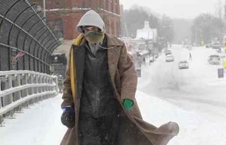 Mark Vonduyke tried to stay warm in the bitter cold as he walked down Walnut Street in Newton.
