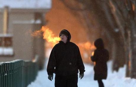 Despite the snow and frigid temperatures, Paige Gill of Boston walked along Memorial Drive.
