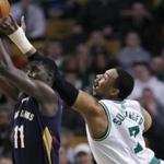 Jared Sullinger reached high as he tried to knock the ball free from Jrue Holiday’s grip in the first quarter.