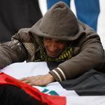 Mohammed Layth Ahmed wept over the coffin of his father, Layth, a soldier who was killed during clashes in Ramadi. His funeral was held in Najaf on Monday.