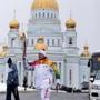 A torchbearer carried the Olympic flame on Thursday in Saransk, about 320 miles east of Moscow.