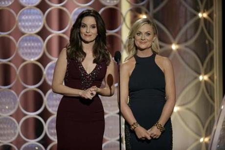 Golden Globe Awards hosts Amy Poehler (right), winner for best actress in a TV comedy, and Tina Fey.
