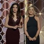 Golden Globe Awards hosts Amy Poehler (right), winner for best actress in a TV comedy, and Tina Fey.