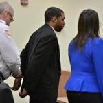 State Rep. Carlos Henriquez of Dorchester was handcuffed after being convicted on two counts of assault and battery. 
