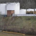 Workers inspected an area outside a retaining wall around storage tanks where a chemical leaked into the Elk River.
