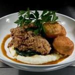 Top: Buttermilk fried chicken, served with potato puree, spinach, barbecue syrup, and plump doughnut holes. Above: the house salad board with greens, tomatoes, green beans, goat cheese, and bacon. 