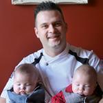 Bistro du Midi chef/partner Robert Sisca with his twin 4-month-old win boys, Hunter (left) and Jameson. 