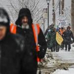 NH Rebellion walk participants plodded their way up Main Street in Belmont, N.H., on Sunday. The two-week walk wraps up Friday.