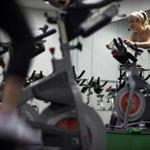 Dedicated fitness buffs powered through a spin class at Flywheel Sports, which is among the specialized studios thundering into Boston.