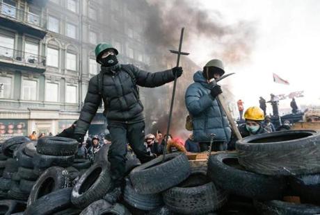 Protesters stood on a barricade during an anti-government protest in downtown Kiev, Ukraine on Friday. 
