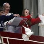 Pope Benedict XVI watched as children released doves during the Angelus prayer in Saint Peter's Square at the Vatican on Sunday.
