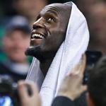Ex-Celtic Kevin Garnett smiles during a video tribute to his career in Boston.