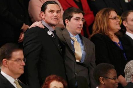Carlos Arredondo and Jeff Bauman at the speech Tuesday. The pair have become close since the Marathon bombing.

