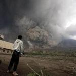 A resident looked at giant volcanic ash clouds from a village in Karo district during the eruption of Mount Sinabung. 