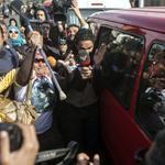 A vehicle transporting a lawyer in the Morsi case was surrounded Saturday in Cairo by both protesters and journalists.