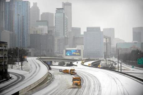 Snow plows cleared a highway in Atlanta on Wednesday.
