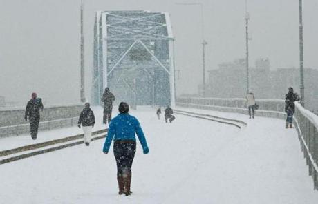 Residents walked across the Walnut Street Bridge as snow deepened in Chattanooga, Tenn.
