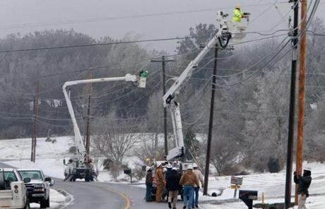 Crews worked on power lines that had grown heavy with ice in Dog Town, Ala.

