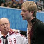 Evgeni Plushenko, with coach Alexei Mishin, left the ice after withdrawing from competition. 