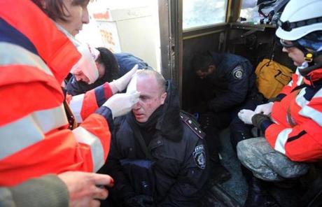 Red Cross workers gave first aid to policemen wounded during the clashes.
