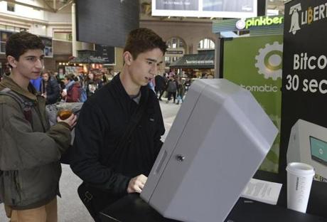 Boston, MA 021914 Friends Nick Pretti (Cq), 17 (left), and Davis Foster (Cq), both from Wellesley check out the Liberty Teller machine for Bit Coin ATM machine on its first day February 19, 2014 at South Station. (Essdras M Suarez/ Globe Staff)/BIZ
