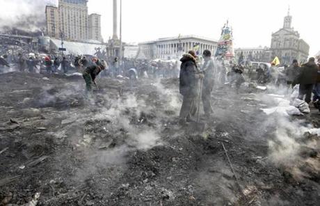 Protesters clean the Independence Square after clashes with riot police.
