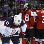 Patrice Bergeron celebrated Canada’s semi-final win with his teammates as Team USA's Phil Kessel (left) skated away. 
