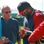 Designated hitter David Ortiz (right) signed an autograph as team president Larry Lucchino looked on.