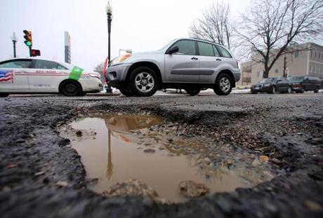 Potholes, like the one above on East Broadway, can claim a hubcap, as one did on Memorial Drive in Cambridge. A cobblestone history is revealed on Berkeley Street.
