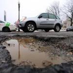 Potholes, like the one above on East Broadway, can claim a hubcap, as one did on Memorial Drive in Cambridge. A cobblestone history is revealed on Berkeley Street.