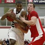 Harvard’s Wesley Saunders was carrying on despite the defense of Cornell’s Dwight Tarwater, who simply tried to hang on.