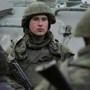 Armed servicemen stood near their armored personnel carrier in the Crimean city of Feodosiya on Sunday.