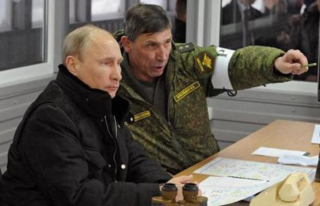 Russian President Vladimir Putin listened to General Ivan Buvaltsev (right) as they observed a military exercise near St. Petersburg, Russia.
